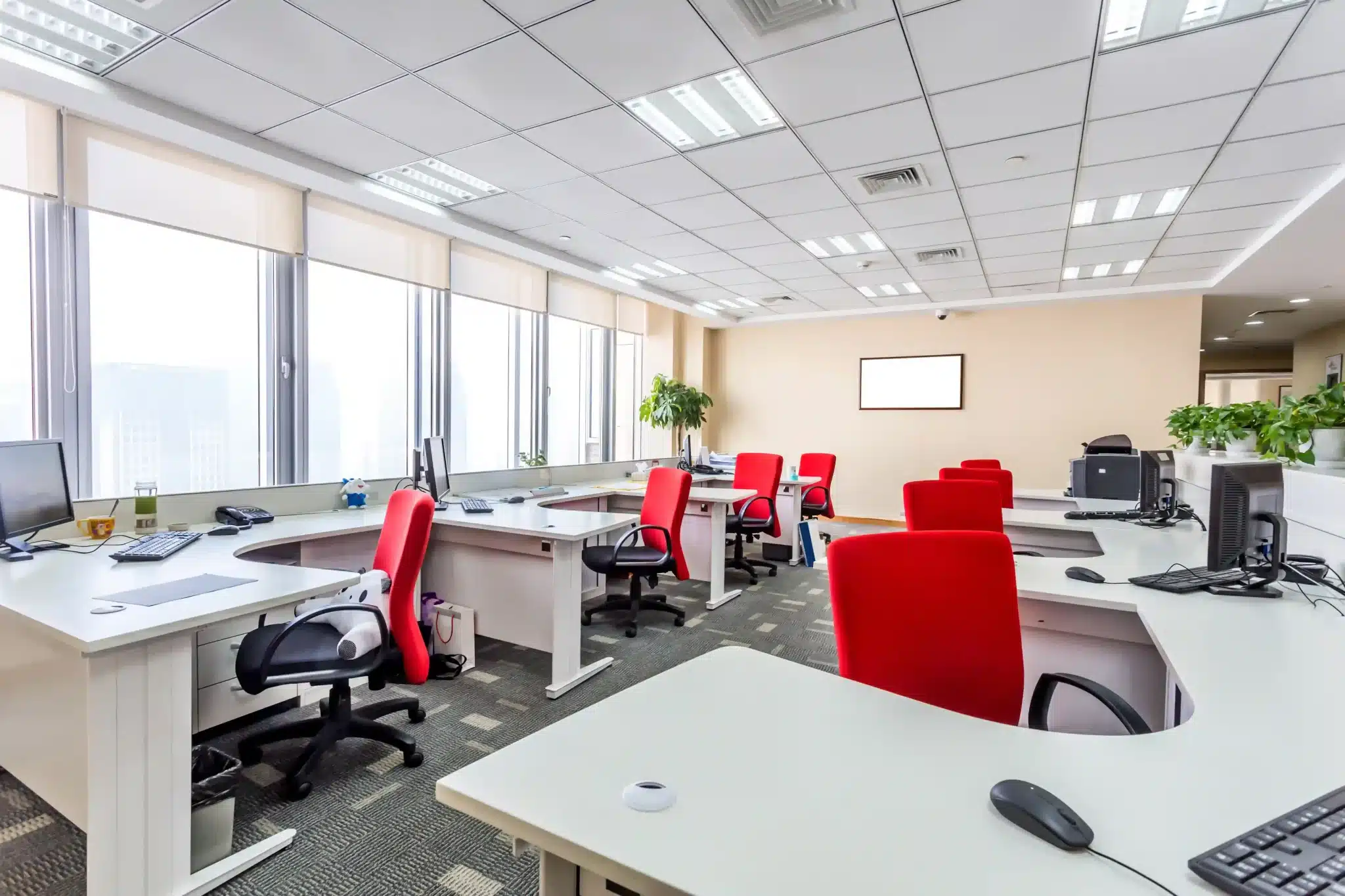 A modern open-plan workspace featuring coordinated desks and red ergonomic chairs from a professional office furniture supplier Malaysia.