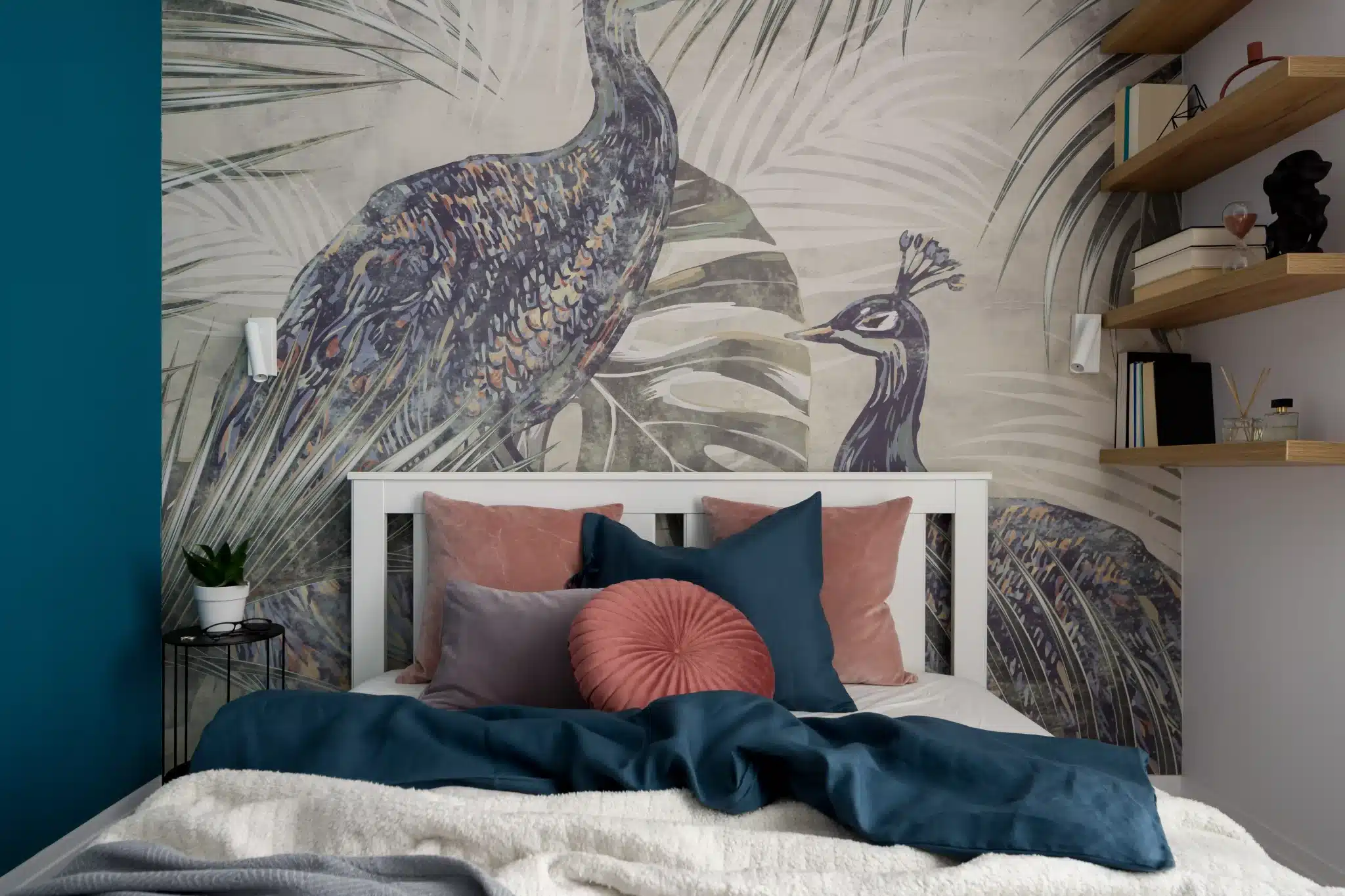 A modern white king size bed frame malaysia styled with deep blue bedding and pink pillows against a peacock wallpaper backdrop