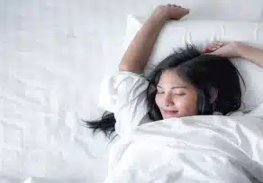 Woman sleeping peacefully on a comfortable queen size mattress in Malaysia.