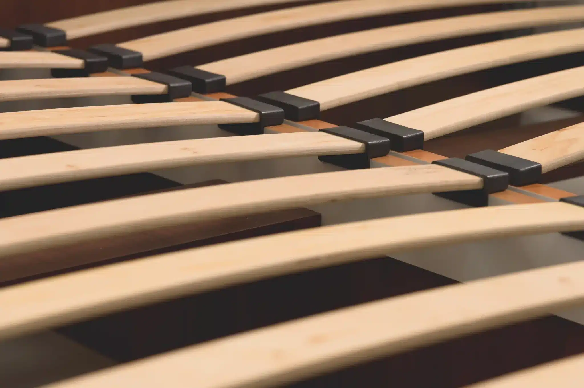 Close-up of evenly spaced wooden slats on a slatted bed frame Malaysia homes use for mattress support.