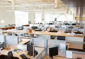 Modern office workstation malaysia setup with frosted glass partitions in a spacious open-plan office environment.