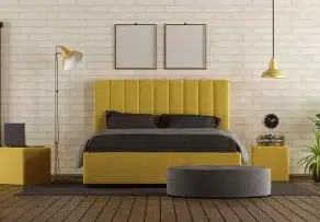 Modern yellow upholstered bed frame Malaysia set against a white brick wall in a stylish bedroom