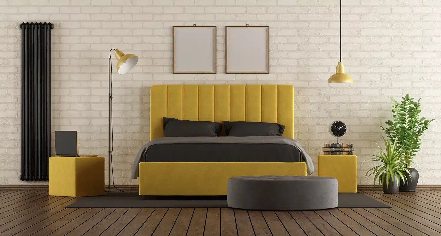 Modern yellow upholstered bed frame Malaysia set against a white brick wall in a stylish bedroom
